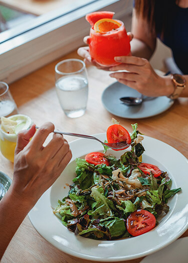 Salad and drink with citrus garnish