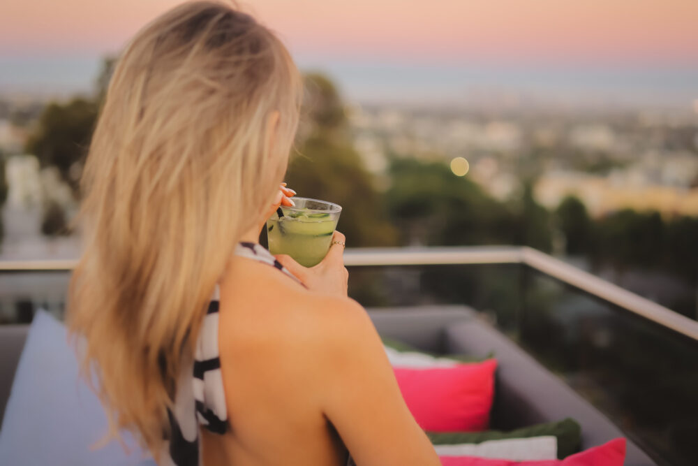 Woman sips on drink with view